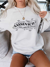 Load image into Gallery viewer, Printed Sudadera Scotland's Own Sassenach Medicines Since 1743
